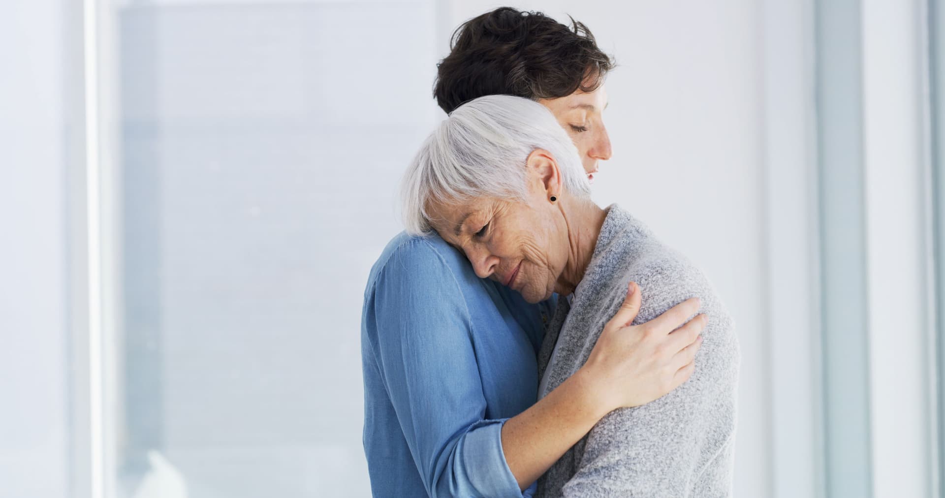 A warm embrace between an elderly woman and her loved one, symbolizing the importance of family connection in nursing home care.